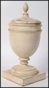 An Edwardian wooden painted campana urn and lid, circa 1900. Square plinth base with campana