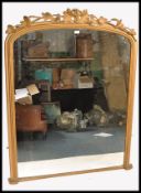 A large 19th century gilt wood and plaster arch top mirror. The large mirror with arch frame