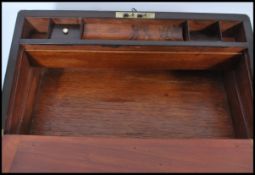 A 19th century Georgian walnut and brass bound writing slope of large rectangular form with bramah