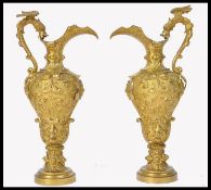 A pair of 19th century classical gilt brass ormulu water ewer jugs. Of classical form, eachg being