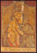 A 19th century painted wooden religious icon - ikon depicting Mary & Jesus Christ. The red ground to