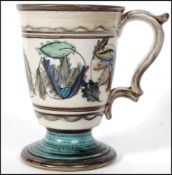 An early, circa 1910 Moorcroft large mug in an unusual Faience design being signed to the bottom