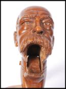 An unusual pair of 19th century wooden nutcrackers. The nutcrackers with carved head of a