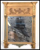 A classical 20th century antique revival twin candelabra overmantel wall mirrorÿ having gilded
