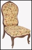 A 19th century Victorian rosewood ladies open armchair. Raised on reeded shaped legs with brass