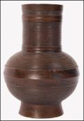 A believed 19th century Chinese Oriental bronzeÿ Gu vase of cyilndrical form with bulbous ribbed