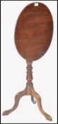 A 19th century George III solid mahogany tilt top wine table. Of slender proportions being raised on