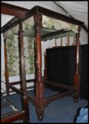 A mid Victorian 19th century solid mahogany four poster double bed. The footboard with tall tapering