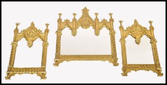 A stunning decorative ecclesiastical gilt metal triptych mirror in the manner of AWN Pugin. The