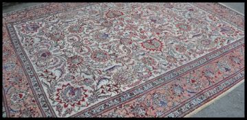 An early 20th century large Tabriz carpet rug. The rug with attractive palatte of colours having