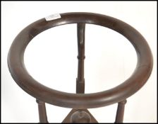 A 19th century George III mahogany washstand, circa 1800 being raised onÿ turned columns and splayed