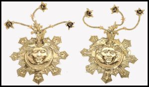 An exceptional pair of 20th century antique revival sun god wall lights - candelabra. Each with 3