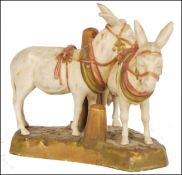 A Royal Dux figural group no 1111 circa 1900, modelled as two harnessed donkeys on naturalistic base