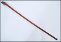A 19th century Victorian unusual walking stick cane with carved tribal African pommel top over