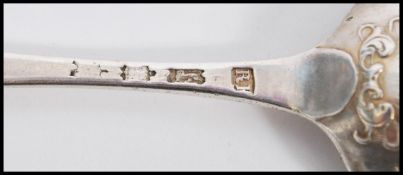 Two 18th century George III silver hallmarked shell back table spoons in the Hanoverian pattern