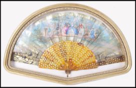 An 18th century Chinese ladies fan with tortoiseshell stems and painted with paper decoration