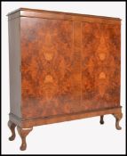 A good early 20th century walnut estate / library bookcase cabinet. Raised on stub cabriole legs