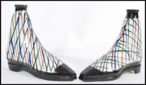 A pair of 19th century Scottish pottery gin flasks in the form of side lace boots decorated in