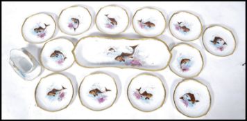 An exceptional 19th century continental porcelain dinner / fish service to include a set of 12