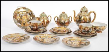 An early 20th century Japanese Meiji period Satsuma part tea service consisting of teapot, creamer