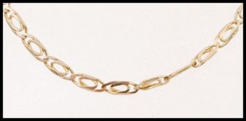 A 9ct gold decorative flat linked chain necklace with a lobster clasp. Weight 7.7g.