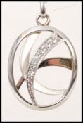 A stamped 925 silver pendant necklace having a oval shaped pendant with inset cz's,. Weight 12.9g.
