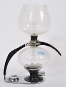 A vintage retro 20th century Cona coffee machine having glass bowl with black and chrome mounts.