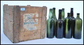 A vintage 19th century wooden shipping crate along with a group of 19th century wine bottles.