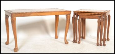 A 20th century hardwood Chinese nest of tables being raised on serpentine legs, each graduating