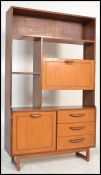 A 1970's Danish teak veneer room divider bookcase being raised on shaped supports with cupboards