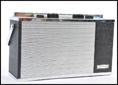 A DISCATRON PORTABLE 7' RECORD PLAYER, pressed chromium and plastic within a black leatherette carry