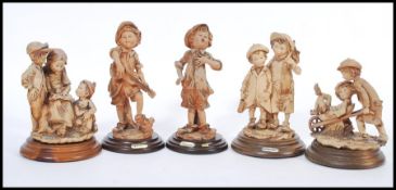 A selection of capodimonte style figurines to include a selection of street urchins having