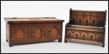A 20th century apprentice piece Jacobean hall settle music box having carved details together with a
