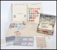 A group of stamps dating from the 19th century contained within two albums with some loose in tin.