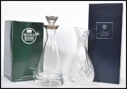 A boxed Thomas Webb clear glass decanter of tapering form having a silver hallmarked collar and