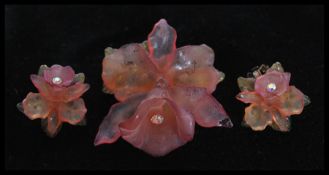 An early 20th century lucite orchid flower brooch pin and earring set. Brooch measures approx 5cm.