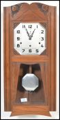 A vintage 20th century Art Deco French walnut cased wall clock, with silvered dial by Vedette having