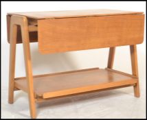 A mid 20th century retro teak two tier  buffet trolley / side table raised of angular form, being