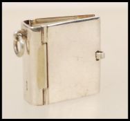 A stamped 925 silver stamp holder book in the form of a pendant. Total weight 15.5g.