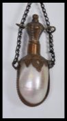 A Victorian French Mother of Pearl chatelaine stoppered perfume bottle with etched metal mounts
