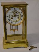Brass four glass clock with twin mercury tube pendulum,