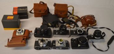 Various vintage cameras including Zenit, Kodak,