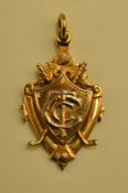 1924 9ct gold winners golf medal - the obverse mounted with shield and letters T.G.C c/w crossed