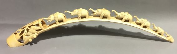 An early 20th century carved tusk Worked with a train of elephants. 70 cm long.