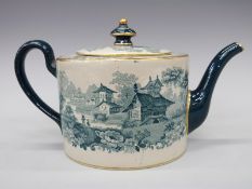 A Victorian transfer printed teapot decorated with buildings in a landscape on a green ground,