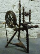 A 19th century or early 20th century oak spinning wheel,