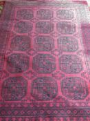 A Turkoman wool rug of red and black design,