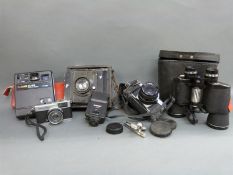 A C.P. Goerz folding plate camera, Canon AV-1 SLR camera with 1:2.