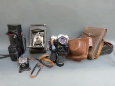 A Zenit-B camera together with Pentacon 50mm lens, Polar f=135mm lens, Prinz 10x40 binoculars,