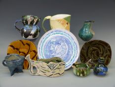Ten pieces of studio pottery by Barry Wade mostly slipware and earthenware, plates, jugs and vases,